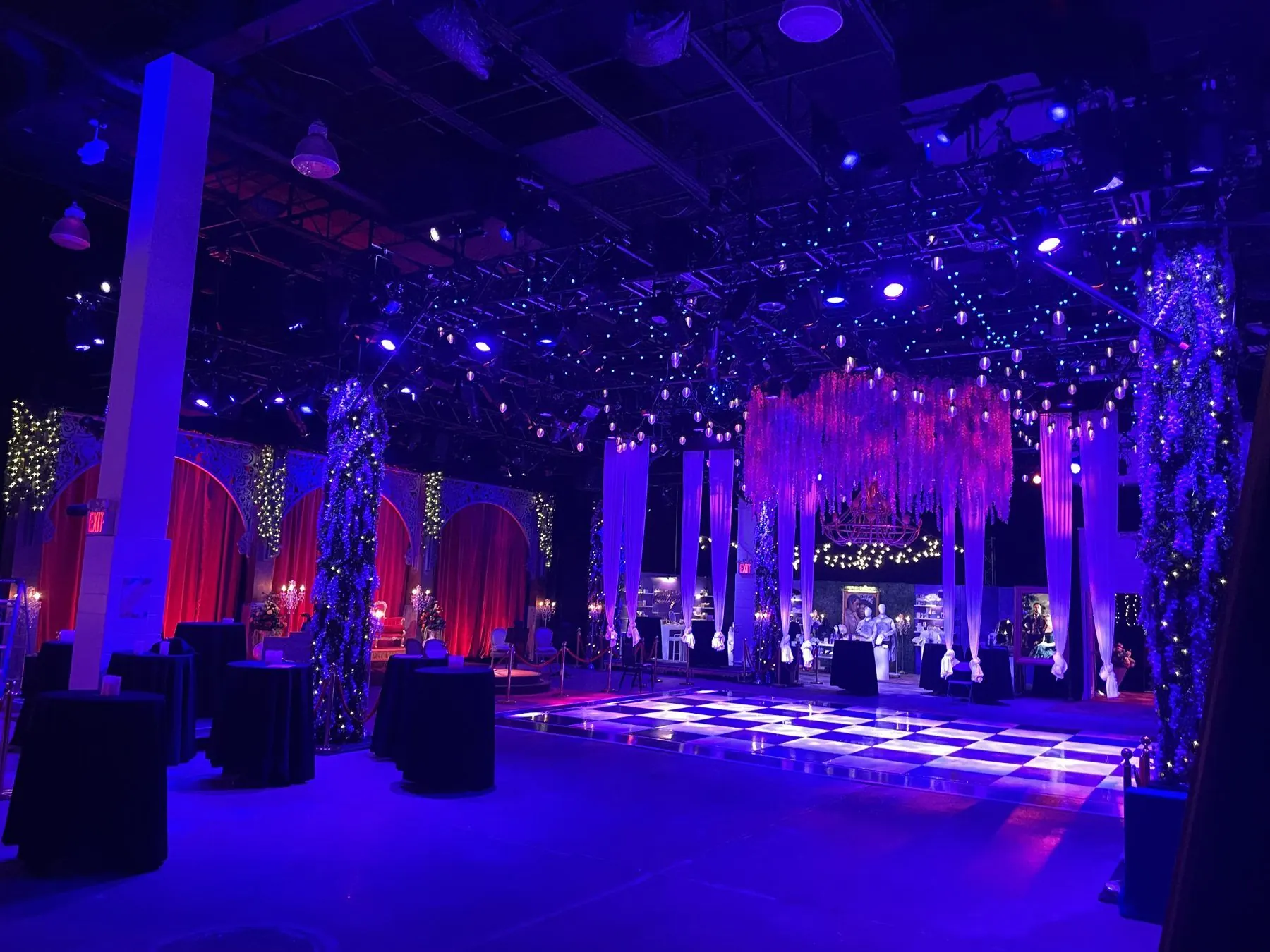 After: garden-themed brand activation with wisteria, drapery and a lit dance floor